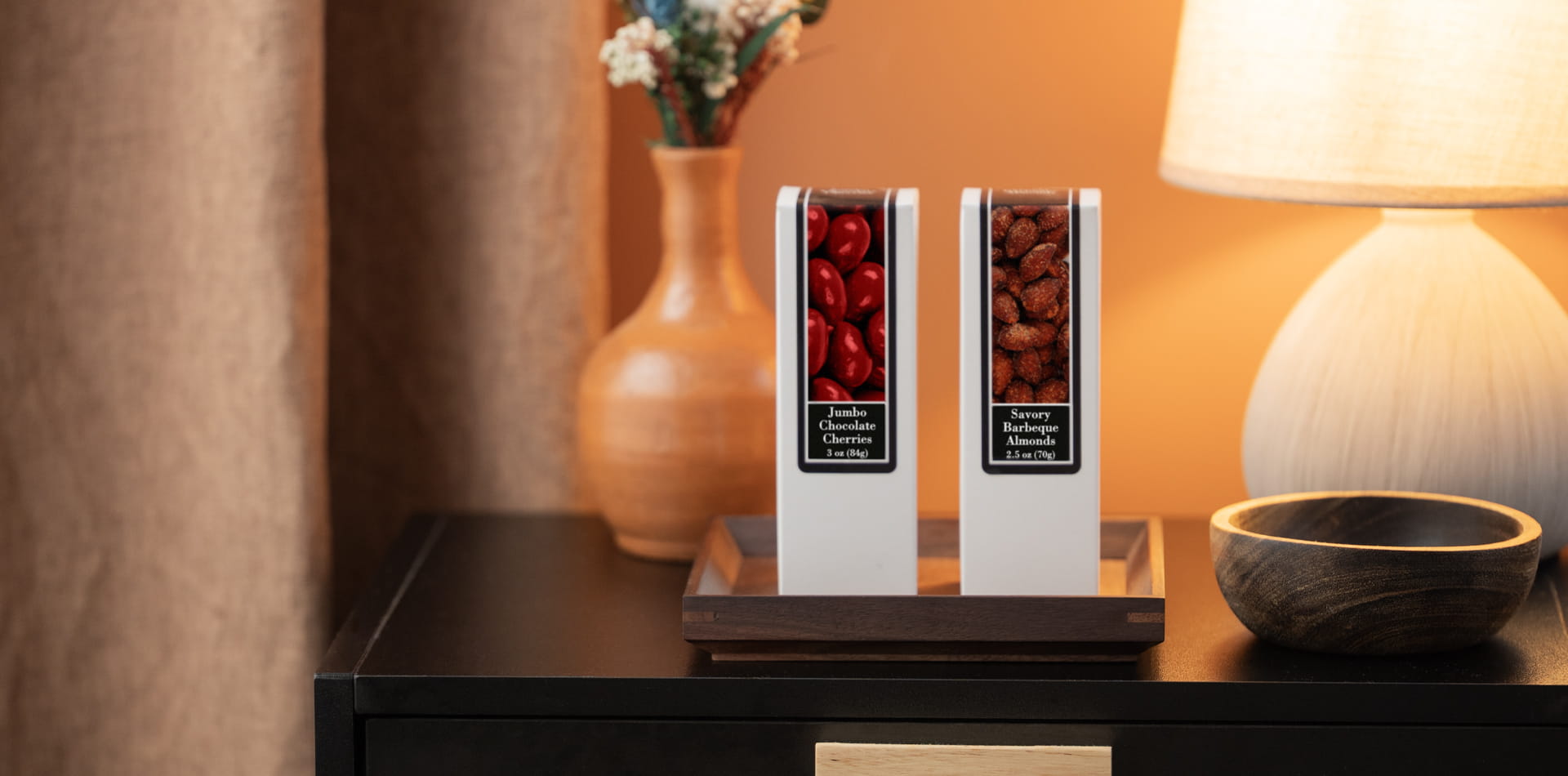Modern boutique hotel welcome tray with premium snacks and water, representing the trend of complimentary minibar.